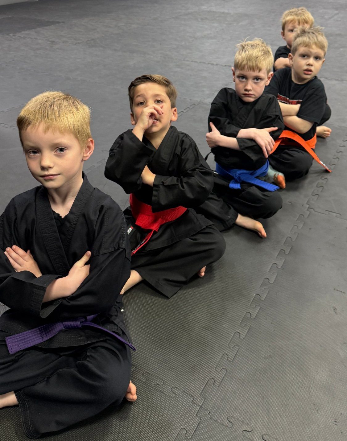 Boys sitting in line in a kids karate class at EWF Martial Arts